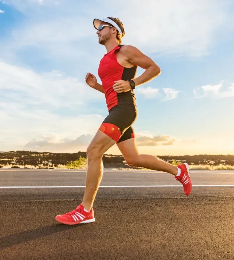 Woman jogging on a sunny park trail